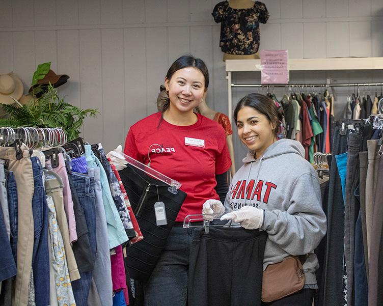 Students volunteeering with PEACE at a thrift store